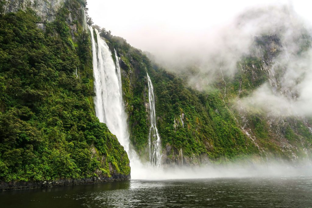 Waterfalls against green cliffs New Zealand