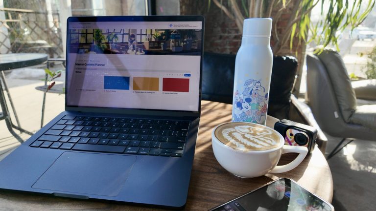 Laptop, coffee, water bottle, sunlight - Writing a Blog for Professionals