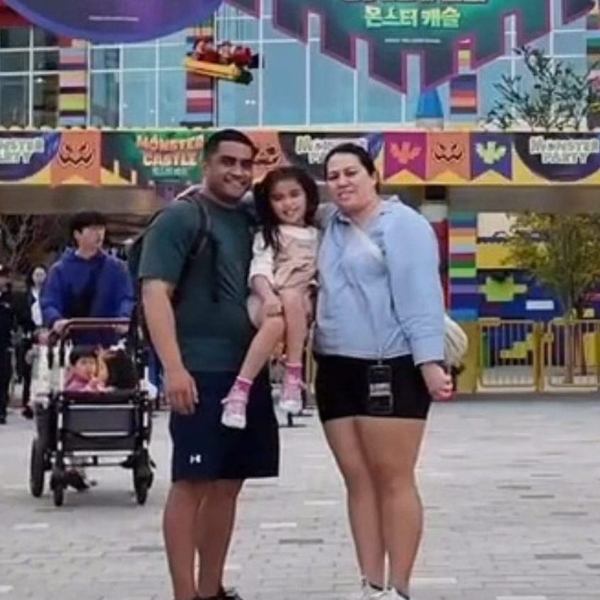 Dad, Mum and Daughter Standing outside the Front of Leogland Korea as they consider moving abroad