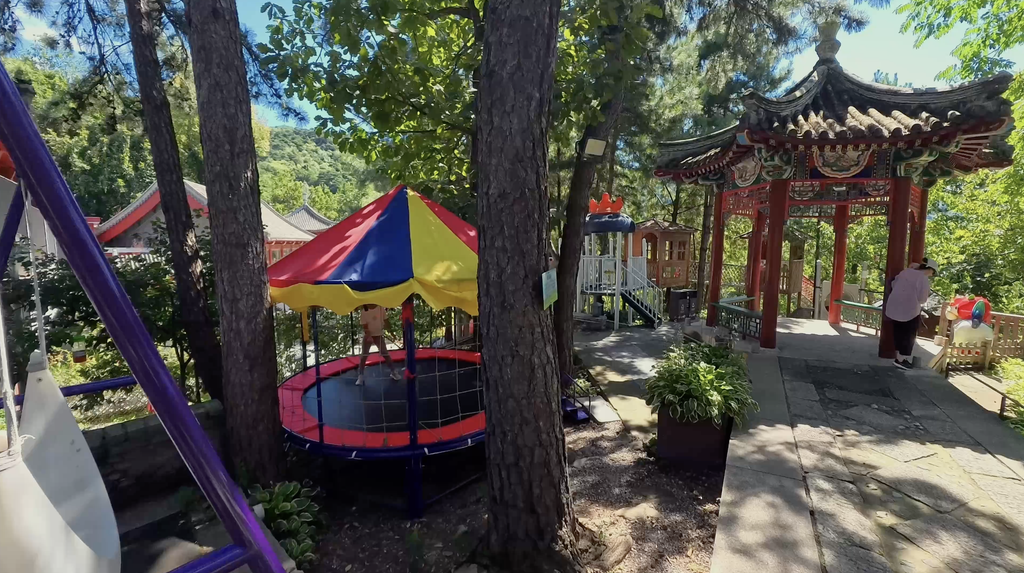 Trampoline and red Chinese pavilion at the kids' playground near Mutianyu Great Wall