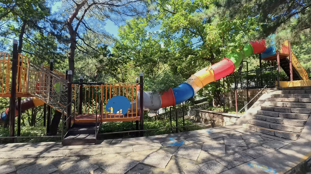 Colourful tube slide at the kids' playground near Mutianyu Great Wall